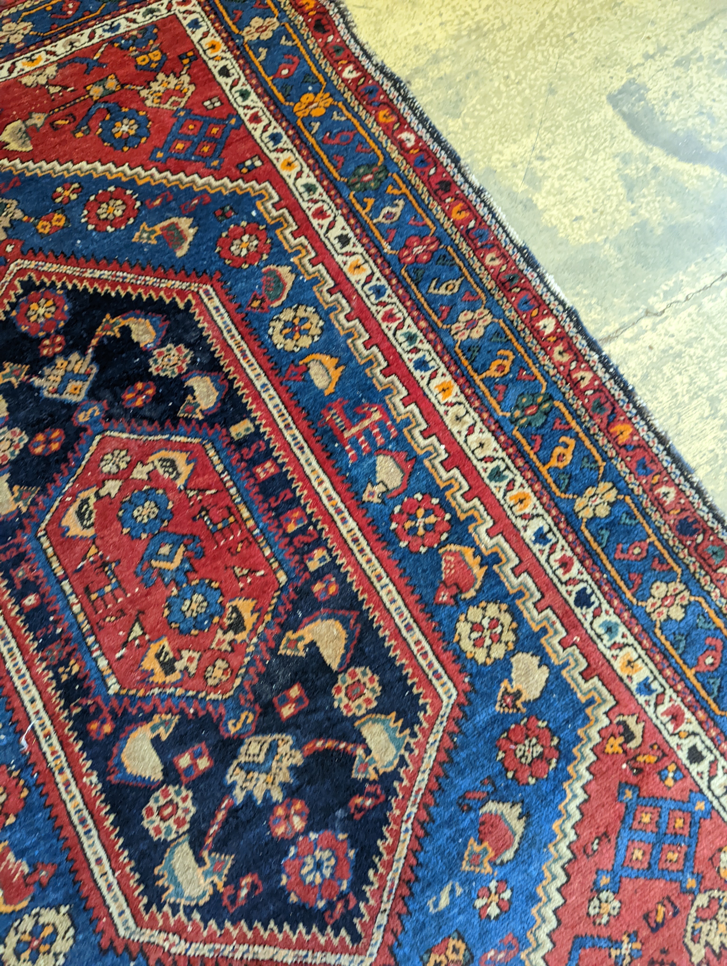 A Caucasian brick red ground rug, 194 x 130cm